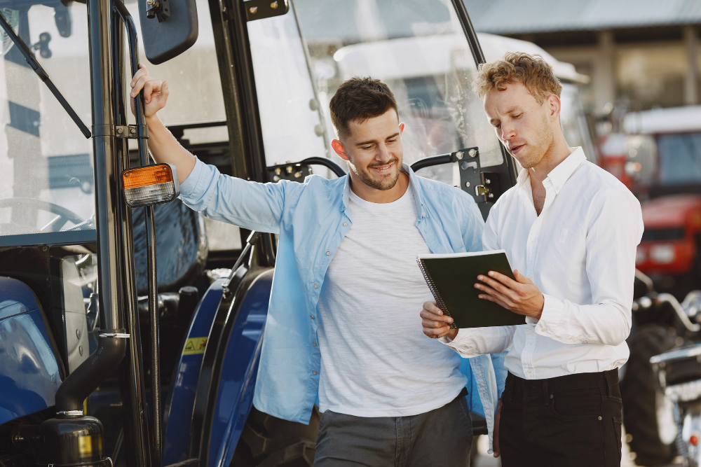 Men reviewing documents about Form 2290 e-file provider services next to a truck.