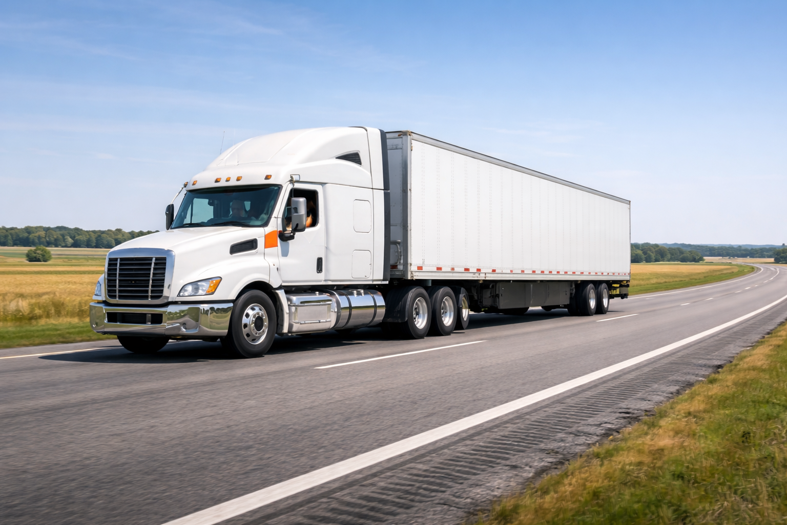 White semi-truck traveling on a highway